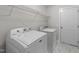 Laundry room with washer, dryer, wire shelf, and marble tile floor at 42 Galaxy Dr, Garner, NC 27529