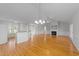 Open-concept living space with hardwood floors, a fireplace, and a large kitchen bar area at 42 Galaxy Dr, Garner, NC 27529