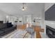 Bright living room with hardwood floors, fireplace, and open floor plan leading to kitchen with seating at 42 Galaxy Dr, Garner, NC 27529