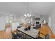 Open-concept living space featuring dining area with kitchen bar, living room with fireplace, and hardwood floors at 42 Galaxy Dr, Garner, NC 27529