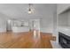 Open-concept living space with hardwood floors, a fireplace, and seamless flow to the adjacent kitchen at 42 Galaxy Dr, Garner, NC 27529