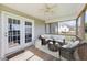Comfortable screened-in porch has a ceiling fan and a cushioned seating area at 42 Galaxy Dr, Garner, NC 27529