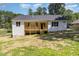 Exterior view of home with wooden deck and stairs, overlooking the partially lawned backyard at 503 Forest Rd, Oxford, NC 27565