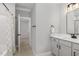 Modern bathroom featuring grey vanity, tiled floors, and shower with modern fixtures at 503 Forest Rd, Oxford, NC 27565