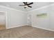 Neutral bedroom featuring a ceiling fan, carpet flooring, and ensuite bathroom at 503 Forest Rd, Oxford, NC 27565
