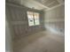 Unfinished bedroom with natural light streaming in from the large window at 503 Forest Rd, Oxford, NC 27565