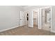 Spacious bedroom featuring neutral walls, plush carpet, and doors to a walk-in closet and additional rooms at 503 Forest Rd, Oxford, NC 27565