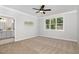 Bright bedroom with carpet, ceiling fan, and ensuite bathroom at 503 Forest Rd, Oxford, NC 27565