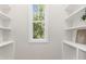 Well-organized walk-in closet featuring built-in shelving and a window at 503 Forest Rd, Oxford, NC 27565