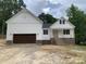 Charming new construction home featuring white siding, a brick foundation, and a two-car garage at 503 Forest Rd, Oxford, NC 27565
