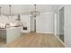 Bright kitchen with a kitchen island, white cabinets, and sliding glass doors at 503 Forest Rd, Oxford, NC 27565