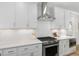 Bright kitchen featuring white cabinets, stainless steel appliances, and subway tile backsplash at 503 Forest Rd, Oxford, NC 27565