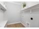 Bright laundry room with storage shelves, a bench, and tile flooring at 503 Forest Rd, Oxford, NC 27565