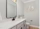 Stylish powder room with a white quartz countertop, sleek black faucet, and black hardware at 503 Forest Rd, Oxford, NC 27565