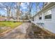 Spacious backyard with partial patio, light gray brick, partially fenced, mature trees, and lots of space for entertaining at 510 Cross St, Sanford, NC 27330