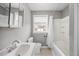 Well-lit bathroom with a tub/shower combo and white fixtures at 510 Cross St, Sanford, NC 27330