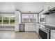 Bright kitchen with white cabinets, stainless steel appliances, and hardwood floors, offering ample countertop space at 510 Cross St, Sanford, NC 27330