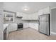 Well-appointed kitchen featuring white cabinetry, stainless steel appliances, and stylish hardwood floors at 510 Cross St, Sanford, NC 27330