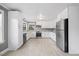 Modern kitchen with white cabinetry, stainless steel appliances, granite countertops, and hardwood flooring at 510 Cross St, Sanford, NC 27330