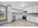 Stylish kitchen with white cabinets, stainless steel appliances, hardwood floors, and plenty of natural light at 510 Cross St, Sanford, NC 27330