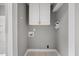 Functional laundry area featuring overhead cabinets and washer/dryer hookups at 510 Cross St, Sanford, NC 27330
