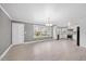 Inviting living space with hardwood floors, large windows, an adjacent kitchen, and a view of the backyard at 510 Cross St, Sanford, NC 27330