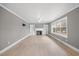 Spacious living room featuring a cozy fireplace, hardwood floors, and ample natural light from large windows at 510 Cross St, Sanford, NC 27330