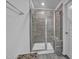 Bathroom showcasing a glass-enclosed shower with seating and gray tile at 5813 Empathy Ln, Raleigh, NC 27616