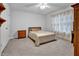 Bright bedroom featuring neutral colors, ceiling fan, and carpeted floors at 5813 Empathy Ln, Raleigh, NC 27616