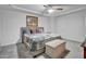 Cozy bedroom with a comfortable bed, ceiling fan and neutral decor at 5813 Empathy Ln, Raleigh, NC 27616