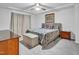 Bedroom featuring a queen-size bed, carpeted floor, and modern ceiling fan at 5813 Empathy Ln, Raleigh, NC 27616