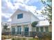 Beautiful clubhouse exterior featuring white siding, large windows, and metal awnings at 5813 Empathy Ln, Raleigh, NC 27616