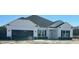 Modern single-story home with black window trim, a dark garage door, and bright white siding at 583 Sweet Potato Lane # 06, Nashville, NC 27856