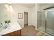 Bright bathroom featuring double sinks, and a glass-enclosed shower at 612 Marian Way, Sanford, NC 27330