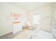 Charming Bedroom with a white crib, a rocking chair, and soft natural light at 612 Marian Way, Sanford, NC 27330