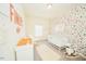 Cozy Bedroom with colorful wallpaper, a white crib, and a rocking chair at 612 Marian Way, Sanford, NC 27330