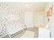 Bright Bedroom with colorful wallpaper, a white crib, and ample space at 612 Marian Way, Sanford, NC 27330