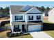 Well-maintained two-story home boasts a white facade, black shutters, and manicured front yard at 612 Marian Way, Sanford, NC 27330