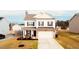 Charming two-story home with stone accents, a two-car garage, and a well-maintained lawn at 612 Marian Way, Sanford, NC 27330