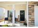 Inviting front porch with stone accents, rocking chairs, and a welcoming 'Welcome' sign at 612 Marian Way, Sanford, NC 27330