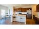 Modern kitchen boasts an island with seating, stainless steel appliances, and light granite countertops at 612 Marian Way, Sanford, NC 27330