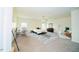 Spacious main bedroom with neutral carpet, ceiling fan, ensuite bath, and sitting area at 612 Marian Way, Sanford, NC 27330