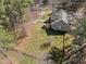Stunning aerial view of a home with a sprawling green lawn, mature trees, and a charming fence line at 6610 Maynard Farm Rd, Chapel Hill, NC 27516