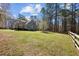 Picturesque backyard featuring a spacious lawn, mature trees, wooden fence providing a private and serene atmosphere at 6610 Maynard Farm Rd, Chapel Hill, NC 27516