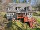 Spacious deck offers an ideal space for outdoor entertaining, surrounded by lush greenery and mature trees at 6610 Maynard Farm Rd, Chapel Hill, NC 27516