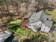 Spacious backyard includes a deck, lush greenery, and mature trees, offering a private outdoor oasis at 6610 Maynard Farm Rd, Chapel Hill, NC 27516