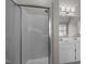Well-lit bathroom featuring a sleek shower with sliding glass doors and double sink vanity at 6610 Maynard Farm Rd, Chapel Hill, NC 27516