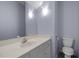 Small bathroom with sink, white vanity, large mirror, decorative lighting, and toilet at 6610 Maynard Farm Rd, Chapel Hill, NC 27516