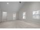 Vaulted ceiling bedroom with a large window and access to the bathroom at 6610 Maynard Farm Rd, Chapel Hill, NC 27516