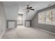 Inviting bedroom featuring soft carpeting, a ceiling fan, and dormer windows for ample natural light at 6610 Maynard Farm Rd, Chapel Hill, NC 27516